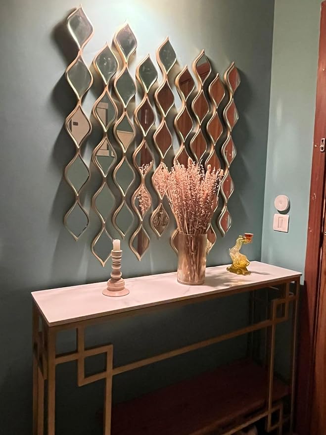 A set of 9 gold teardrop panels arranged on a wall as stylish mirror decor