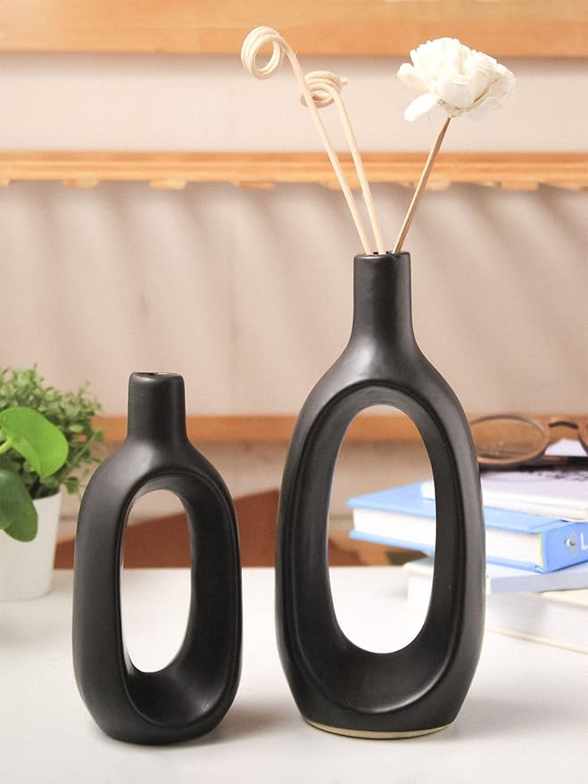 A living room's center table styled with the elegant black ceramic vases for home decor