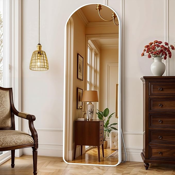 A 5-foot white unbreakable arch mirror with a stand, placed in a modern bedroom