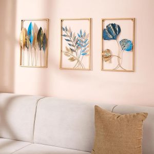 A close-up of the detailed texture on a single golden leaf, part of the metal wall art set