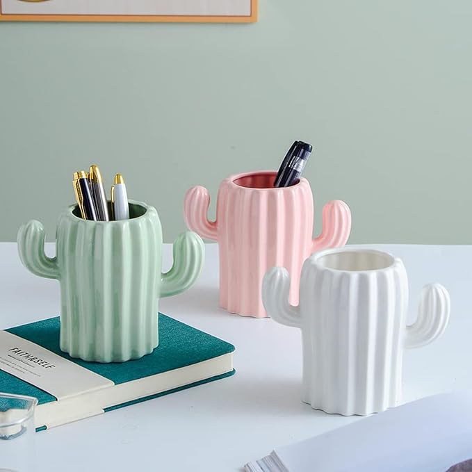 A set of three unbreakable plastic flower pots with unique, modern designs on a tableto