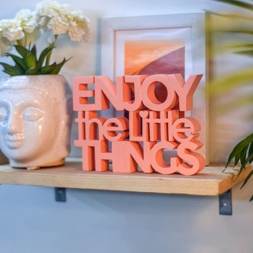 The NUKKAD TALES "Enjoy the little things" showpiece used as desk decor in a modern office